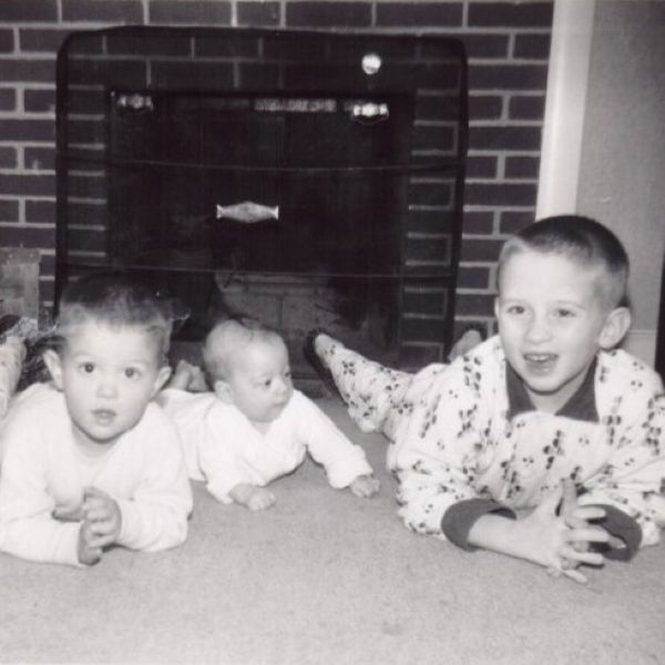 Timmy, David, and Mickey lying prone in front of the fire place