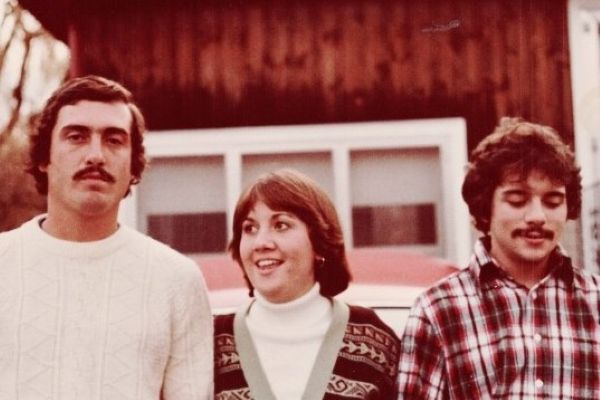 Timmy, Polly, and David standing behind Polly's car on Parker Rd