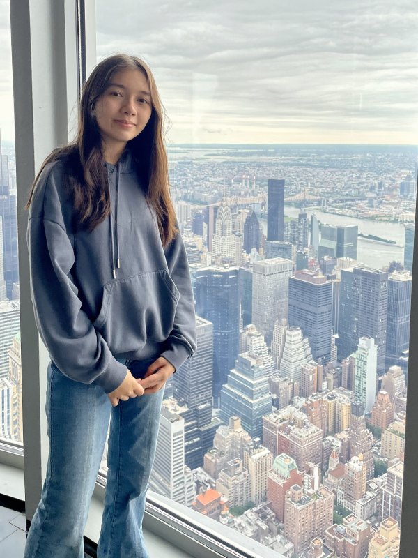 Alba is posed next to a window on the 83rd floor of Empire State Building