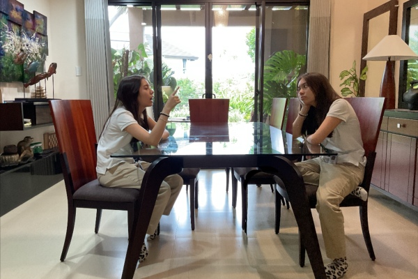 Fourteen year old A;ba picking her nose in a restaurant