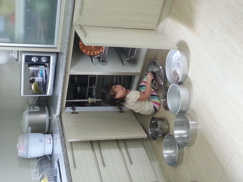Alba at 3 with all the pots pulled of of the cabinet