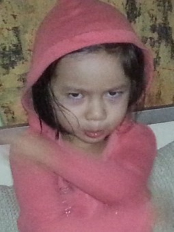 Alba wearing a hood showing anger