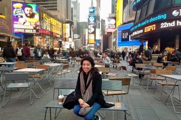 Cher sitting on a bench in NY' Times Square