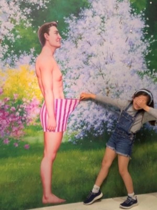 Alba posing with photo of man in boxers